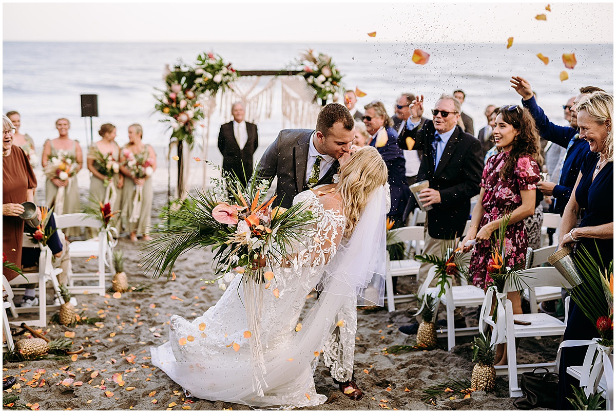 Newlyweds kissing during their Palm Beach beach wedding ceremony