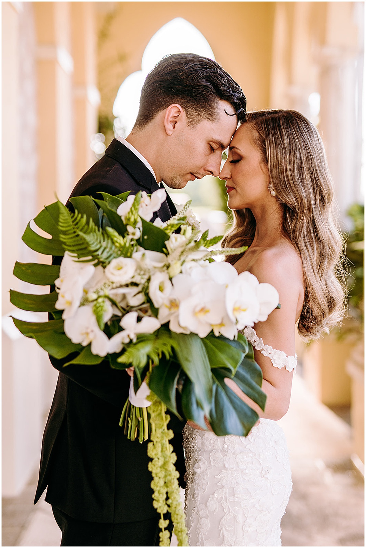 Bride and groom with a tropical wedding bouquet at a Palm Beach wedding