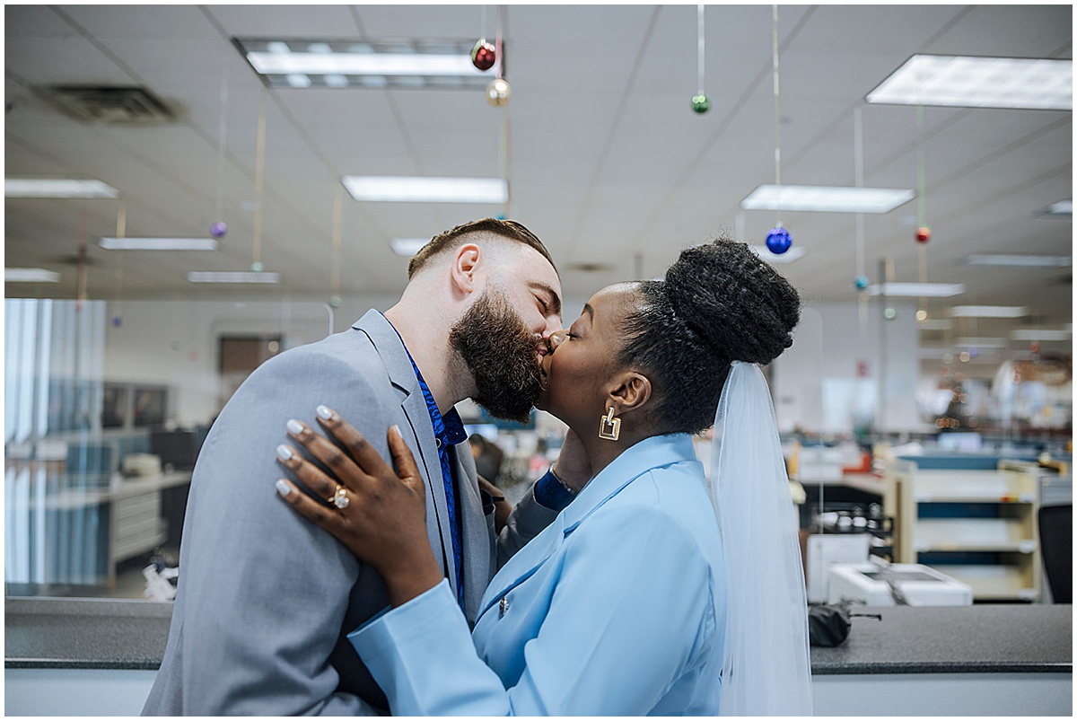 Newlywed couple kissing inside the Palm Beach County courthouse