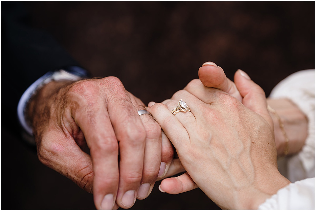 Newlywed couple showing their wedding rings after their Florida wedding