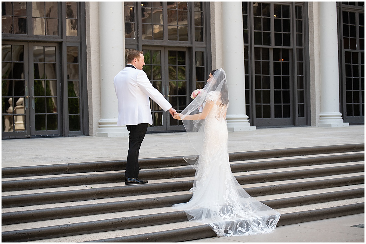 Bride and groom holding hands outside a Palm Beach County wedding venue