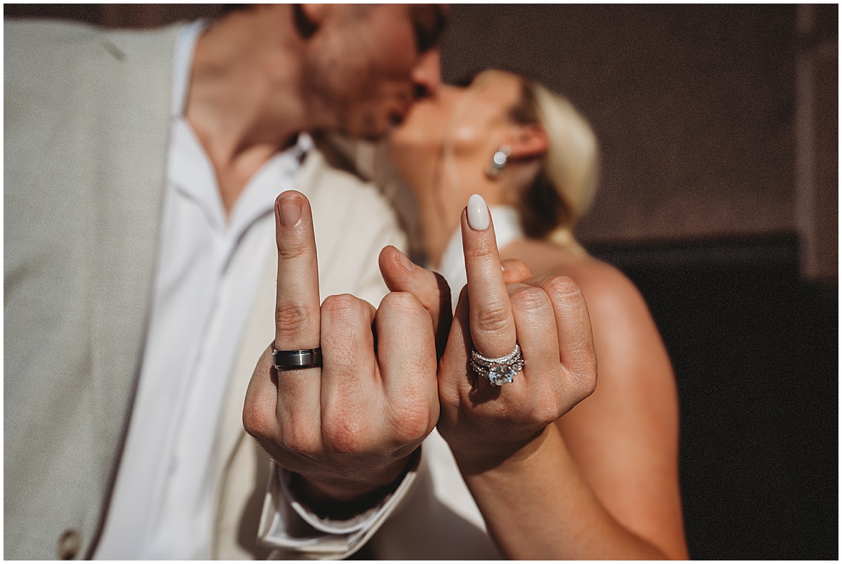 Newlywed couple showing their wedding rings after getting married in Palm Beach County
