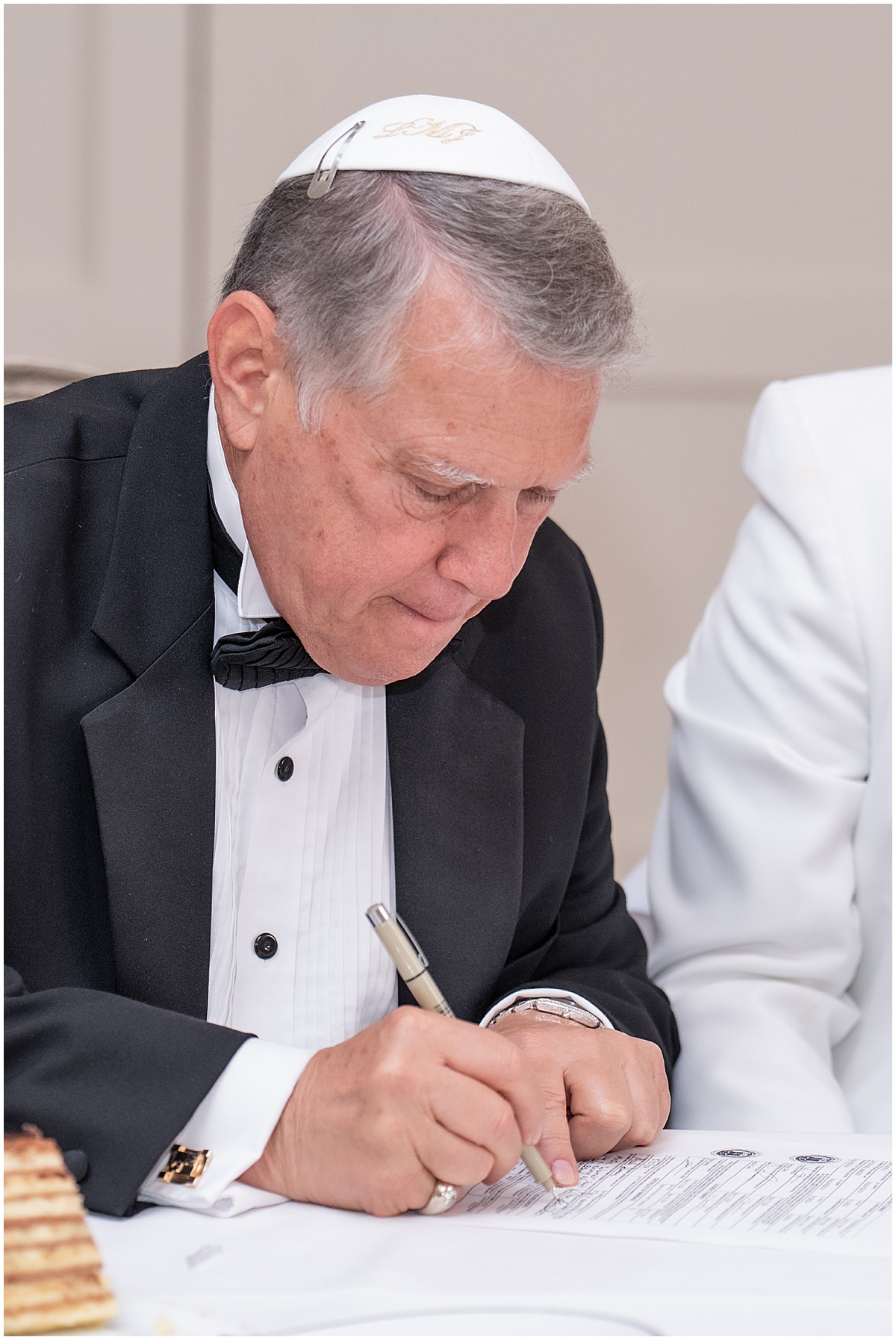 Wedding officiant signing a Florida marriage license after a Palm Beach County wedding