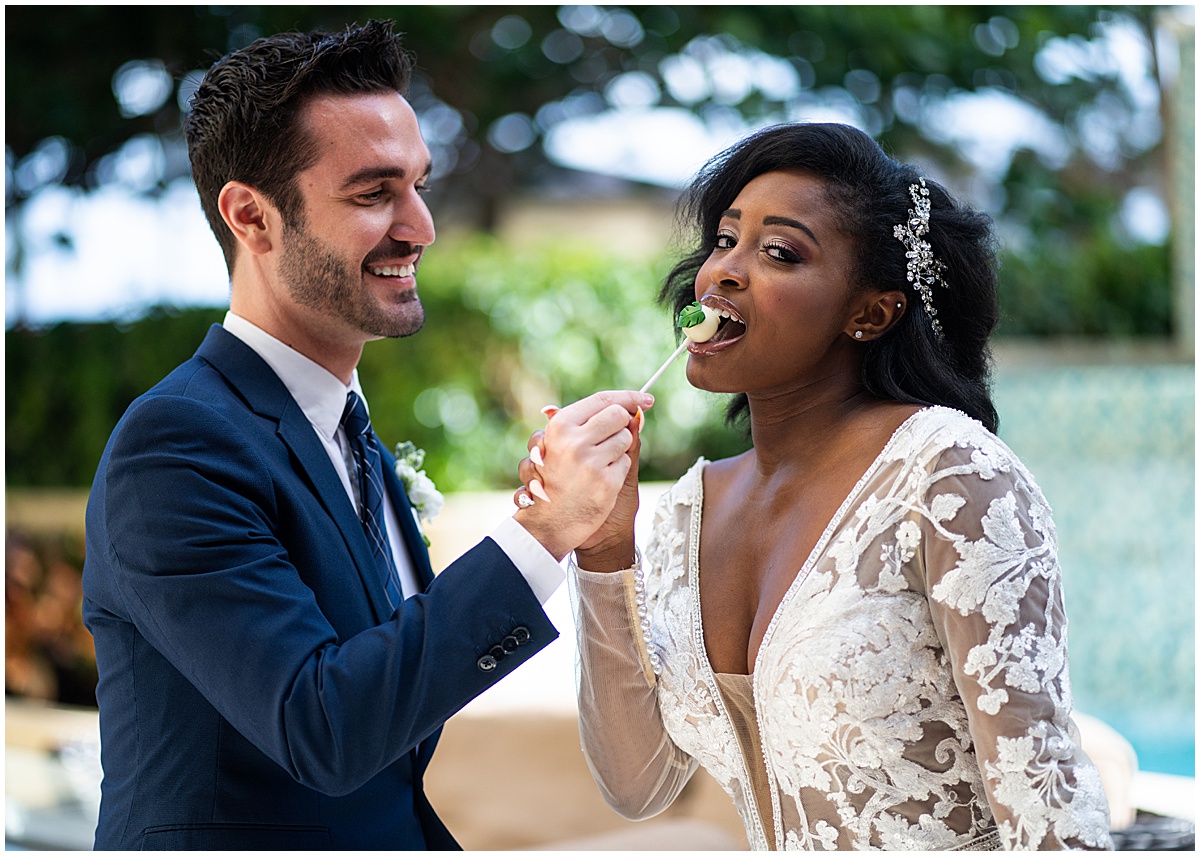 Palm Beach wedding couple sharing a cake pop as an alternative to wedding cake