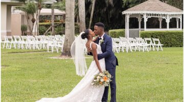 Bride and groom kissing after their outdoor Palm Beach wedding ceremony.