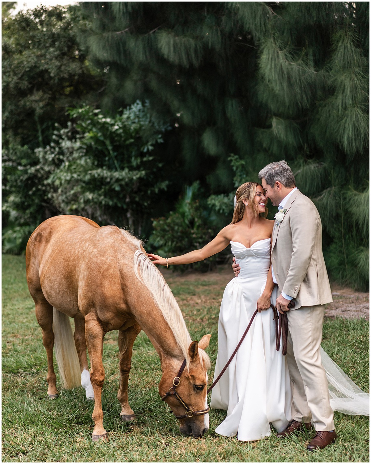 Bride and groom pose with their horse for outdoor Palm Beach wedding portraits