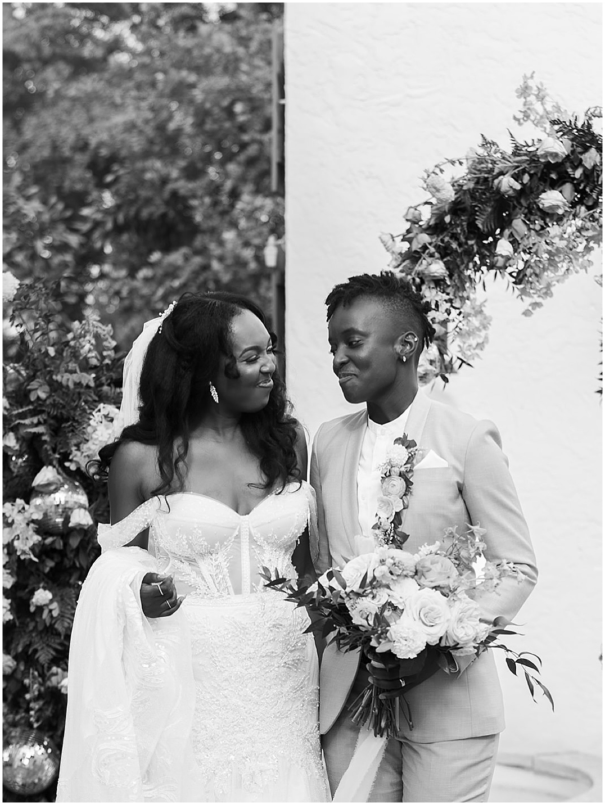 Black and white wedding portrait of two brides holding bouquets in Palm Beach.