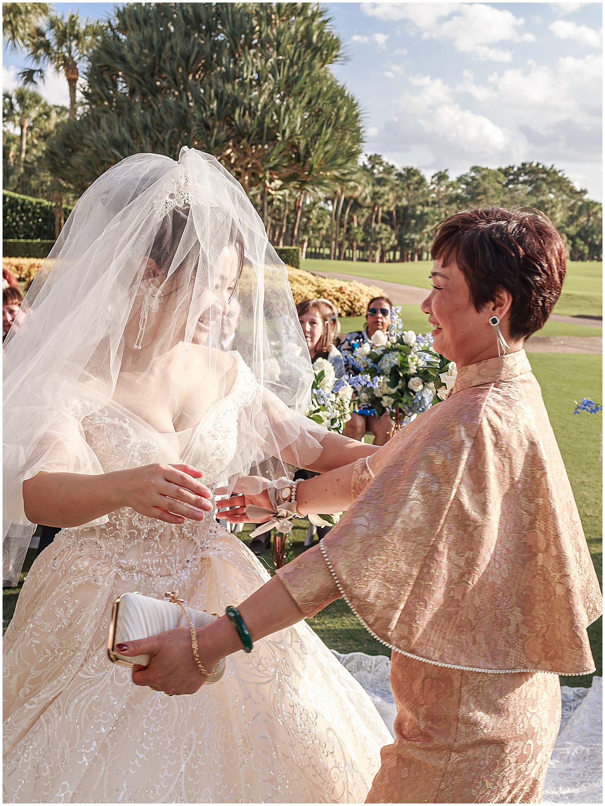 Bride sharing a special moment with her mother during an outdoor Palm Beach wedding.