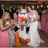 University of Miami mascot Sebastian the Ibis with a bride and wedding party at a Palm Beach wedding