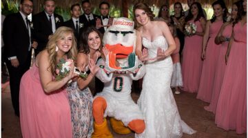 University of Miami mascot Sebastian the Ibis with a bride and wedding party at a Palm Beach wedding