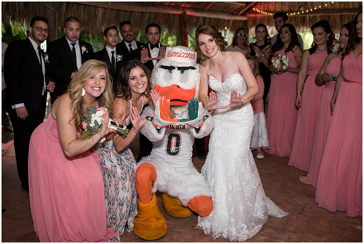 University of Miami mascot Sebastian the Ibis with a bride and wedding party at a Palm Beach wedding