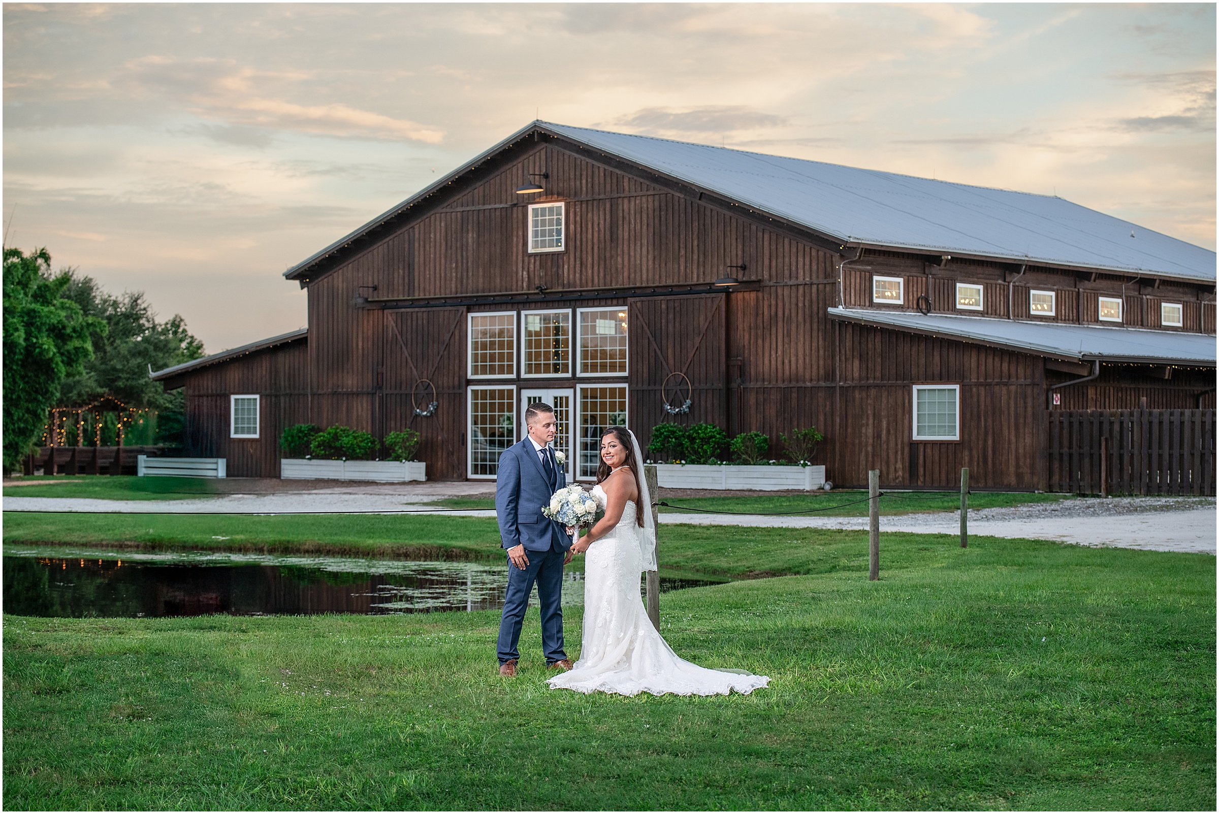 Bride and groom posing outside a rustic barn wedding venue in Palm Beach County.